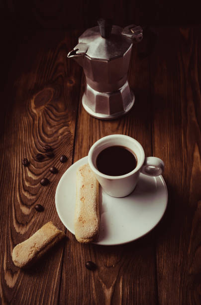 istock Italian Moka Pot coffee maker pot with coffee cup 1253681674