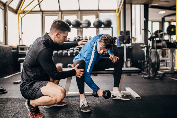 istock Young man having personal training in the gym 1253681953