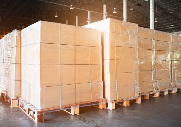 istock Stack of cardboard boxes on wooden pallets. Large shipments goods at interior warehouse storage. Cargo export. Warehouse industry shipping logisics. 1253682100