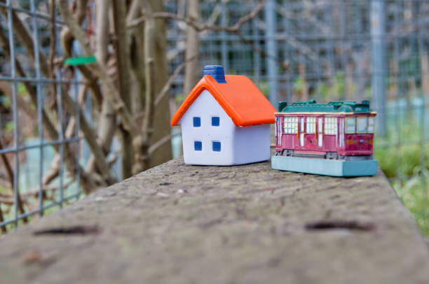 Miniature soft toy house on concrete fence with a toy tram car Miniature soft toy house on concrete fence with a toy tram car australia house home interior housing development stock pictures, royalty-free photos & images