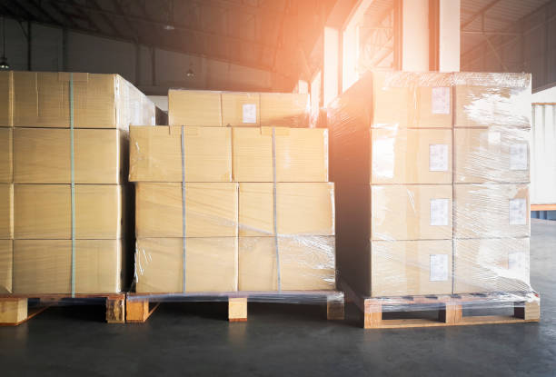 istock Stack of cardboard boxes on wooden pallets. Large shipments goods at interior warehouse storage. Cargo export. Warehouse industry shipping logisics. 1253682129