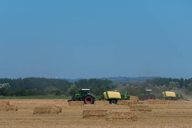 istock heavy machinery in the field performs agricultural work during the summer 1253683155