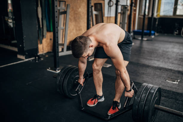 istock One young man weightlifting in the gym 1253684309