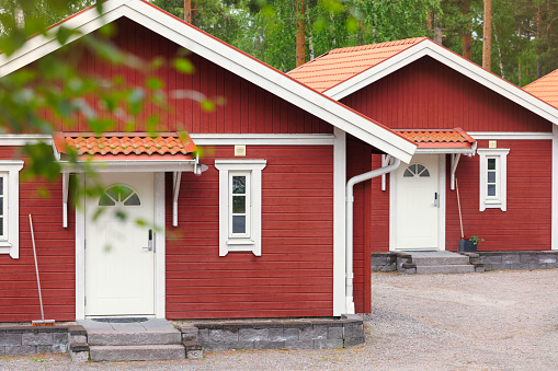 Small red cottages in a row for summer tourists near Lake Runn in the Dalarna county of Sweden.