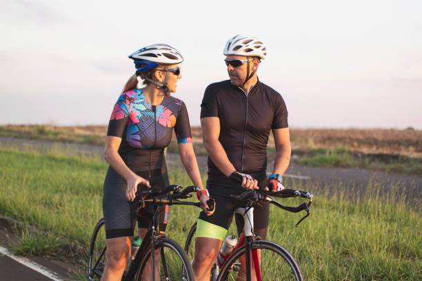 istock Man and woman riding a bicycle 1253690594