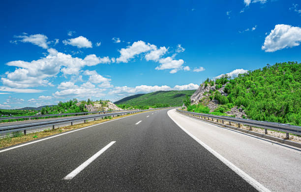 istock Mountain highway with blue sky. 1253691329