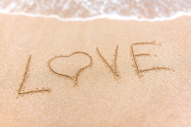 istock Inscription Love on the sand. 1253691353