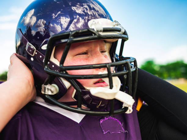 istock Junior Football player getting helmet ready 1253693159