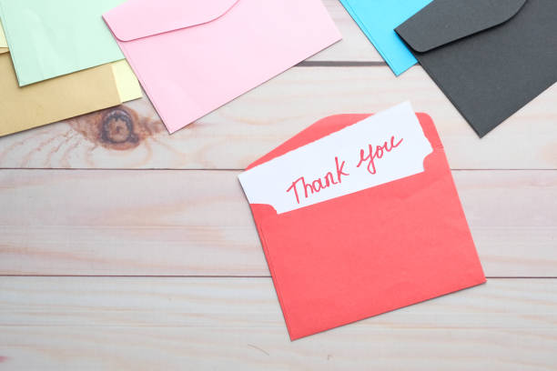 istock thank you message and envelope on wooden table 1253695406