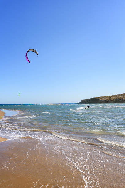 istock Prasonisi beach with kitesurfers surfing in waves (Rhodes, Greece) 1253698775
