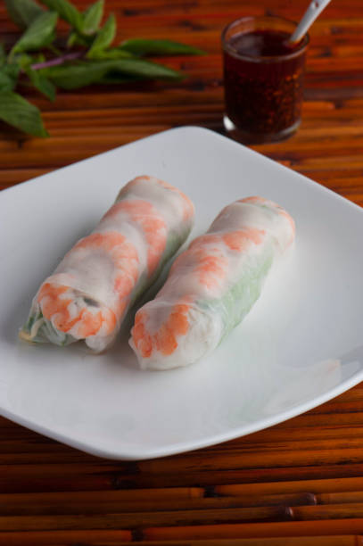 istock Spring-rolls, classic Vietnamese, Thai, Chinese or Korean appetizer. Rice paper filled with vermicelli noodles, shrimp, carrots and shrimp. Served with peanut and spicy sweet and sour sauces. 1253699794