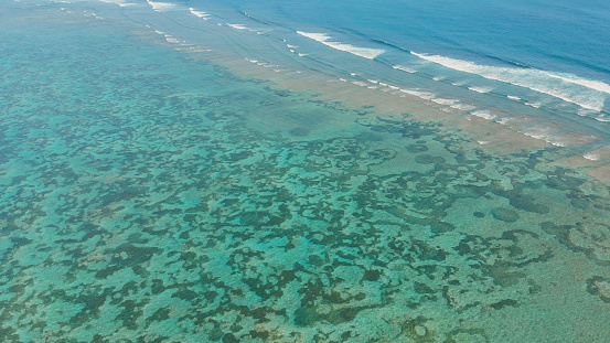 Aerial view of the beautiful ocean floor with reefs near Pantai Pandawa. Indonesia