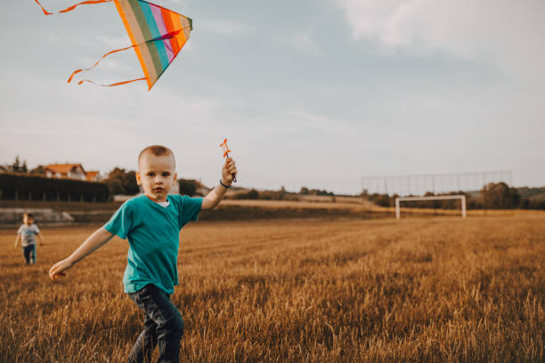 istock Little boy running a kite 1253700503