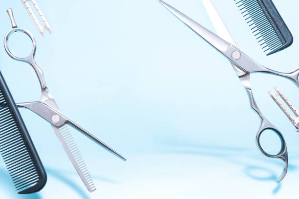 istock Flying hairdresser tools comb, scissors under trendy color background with copy space and soft light. Stylish Professional Barber Scissors, Hairdresser salon concept, Haircut accessories 1253700516