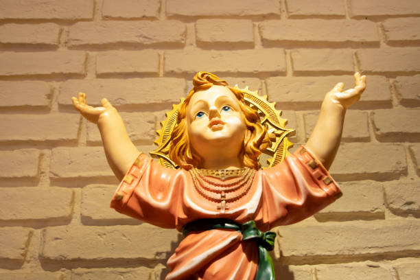 istock Religious Boy Sculpture with Hands Up 1253701768
