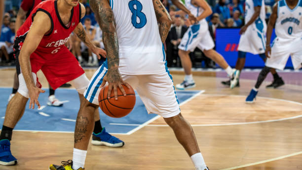 istock Basketball players tackling for ball 1253702744