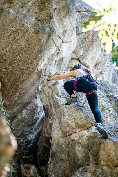 istock Female athlete climbing on the rock mountain 1253702879
