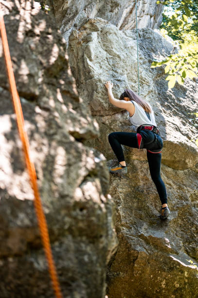 istock Female athlete climbing on the rock mountain 1253702920