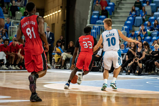 istock Basketball players playing in court 1253703017