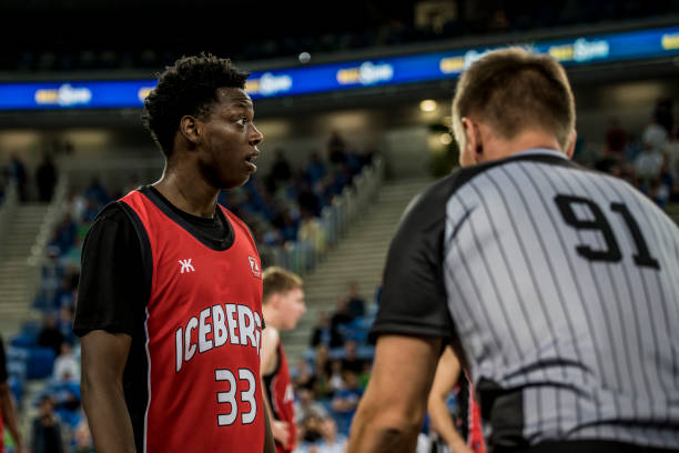 Basketball player and referee standing on court