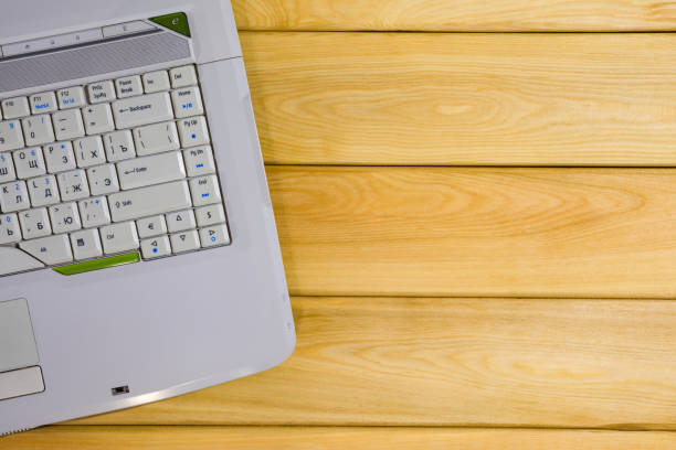 istock laptop on a wooden background top view 1253704070