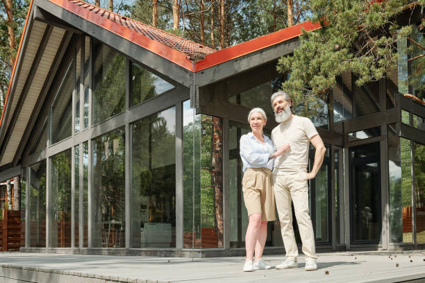 istock Senior couple standing against cottage 1253704289
