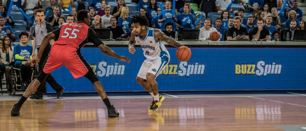 istock Basketball players playing in court 1253704332