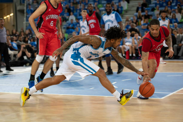 istock Basketball players tackling for ball 1253705246