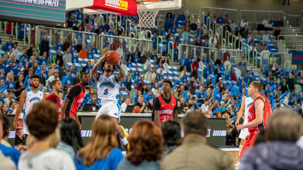 istock Basketball player jumping with basketball 1253705757