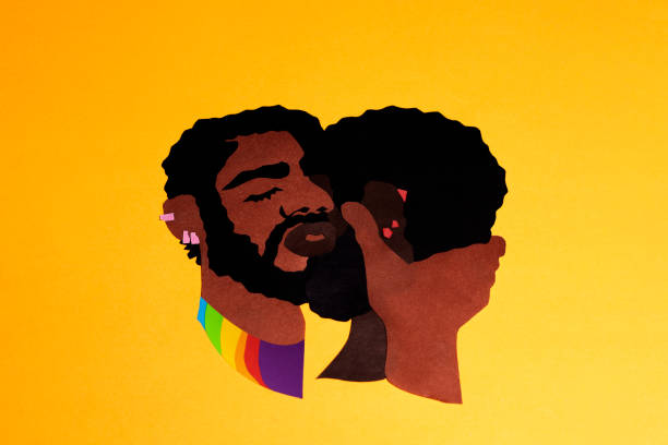 The black men are cut out of colored paper cuddling on an orange background The black men are cut out of colored paper cuddling on an orange background. The photo of handmade paper art was shot for your craft design. bi black stock pictures, royalty-free photos & images