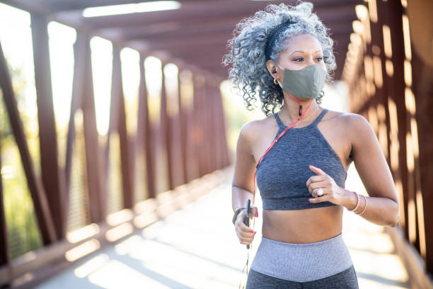 A Black Woman Running on a bridge