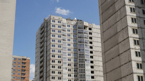istock Large construction site on a background of blue sky. Brick, panel apartment building. Industrial theme for design 1253710242