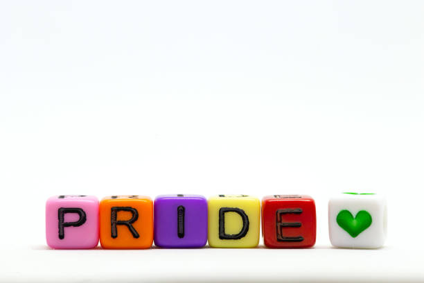 istock PRIDE word written on various rainbow cubes isolated on white background, with colorful symbol of heart lgbt concept 1253710302