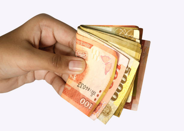 istock Man holding Sri Lankan currency in hand 1253711184
