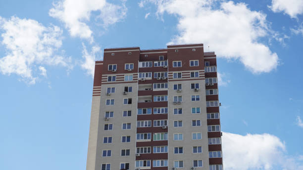 istock Large construction site on a background of blue sky. Brick, panel apartment building. Industrial theme for design 1253711248