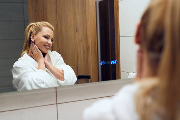 istock Reflection in a mirror of beautiful woman in  bathrobe. 1253713373