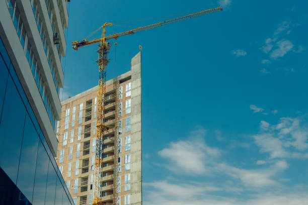 istock high tower construction building industry landmark picture foreshortening from below with crane and clear blue sky background space for copy or your text here 1253717372