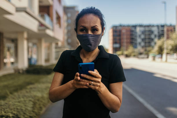 istock Asian woman wearing a protective face mask 1253721531