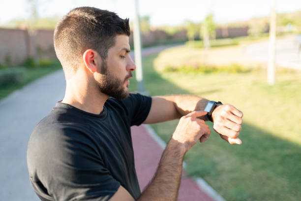 istock Sporty Young Man Checking Time 1253724434