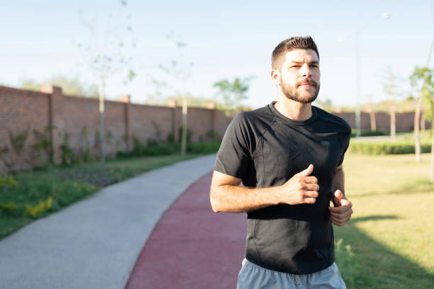 istock Young Man Jogging In Park 1253724453