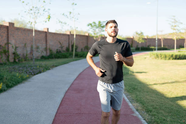 istock Athletic Man Jogging In Park 1253724961