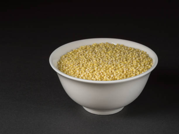 istock Millet in a bowl closeup on dark background. 1253725076