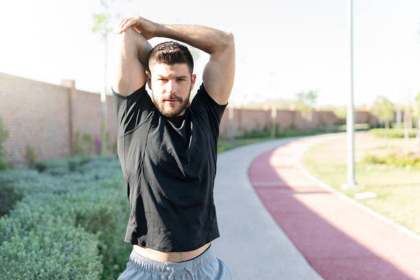 istock Sporty Man Exercising In Park 1253725090