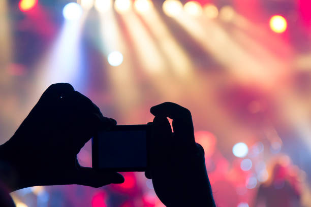 istock Filming concert on smart phone 1253725686