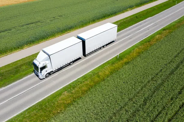 Heavy cargo on the road, aerial view of a truck.