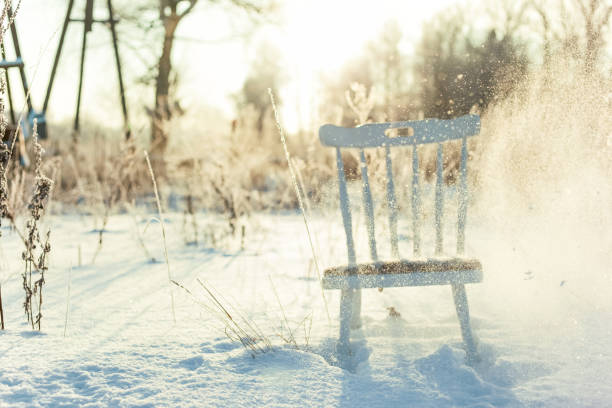Chair in the snow, winter creative background, home office in winter