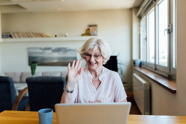 istock Senior woman using a laptop at home 1253726900