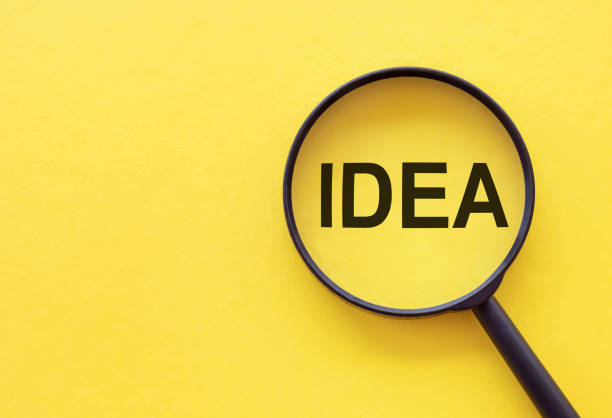 istock Creative idea and innovation concept with magnifier on yellow background 1253728681