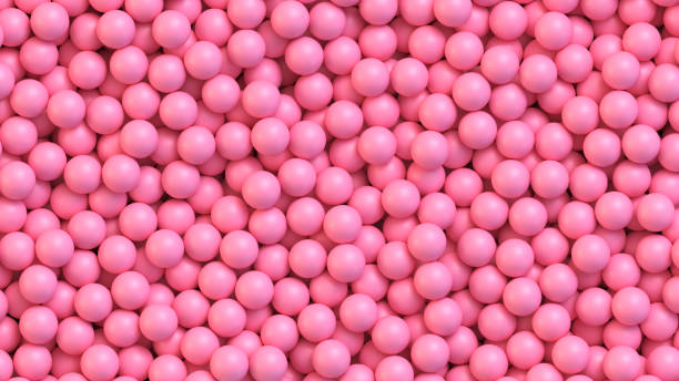 istock Pink candy balls. Pile of pink balls, sugar coated candy 1253728941