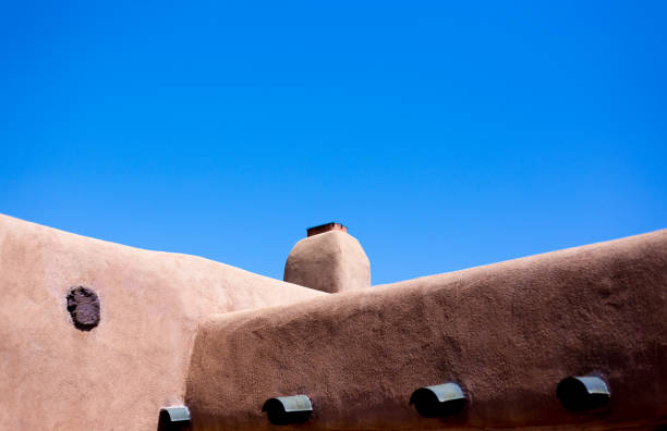 Santa Fe, NM: Old Adobe House Exterior Detail; Blue Sky background with copy space.
